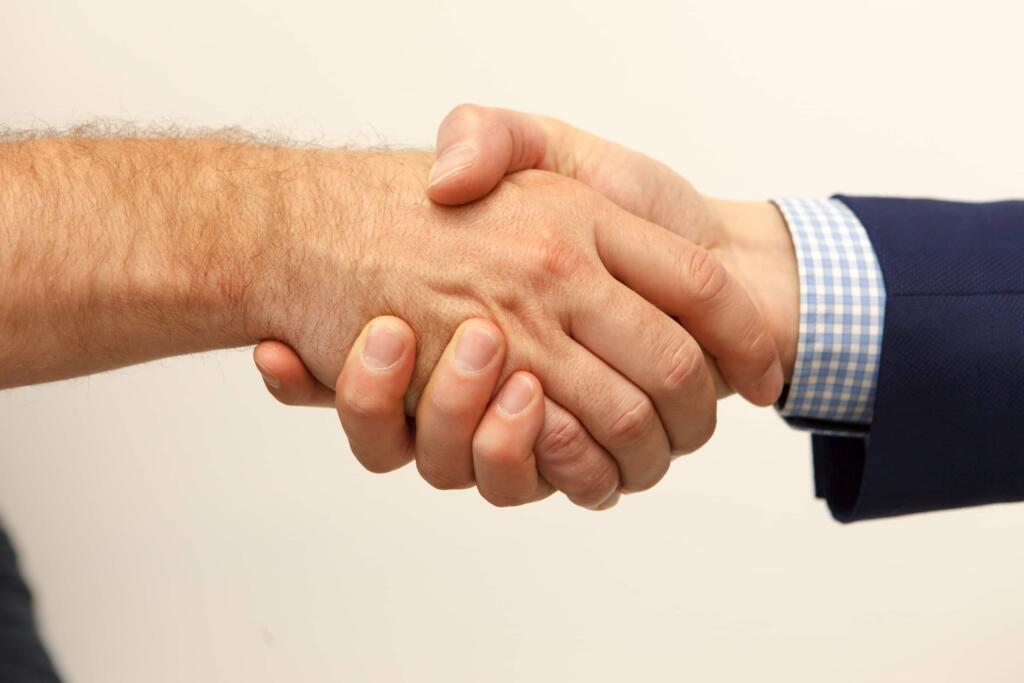 photo of two people shaking hand - real estate lawyer